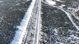 Winter Coat - aerial view of railway tracks and a road in a winter landscape | Trending HD Vide