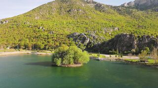 Wallpaper hanging - aerial view of serene mountain lake island | Trending HD Video