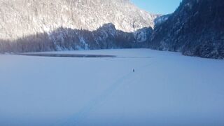 WallPics - 4K Wallpapers - aerial view of serene frozen lake with solo traveler | Trending HD V