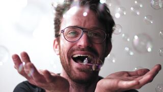 Notes on Being a Man - a man with glasses and bubbles in his hands | Trending HD Video