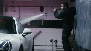 Scarred - man pressure washing a white car | Trending HD Video