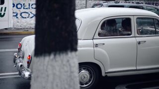 Cartier - a man walking across a street in a rainstorm | Trending HD Video
