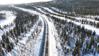 Travelpro - aerial view of a road in a snow covered landscape | Trending HD Video