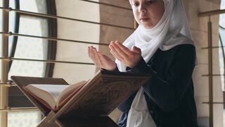 a girl reading and praying the quran | Professional HD Video