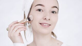 Woman Within - person applying a makeup on her face | Trending HD Video