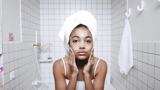 Woman Within - video of woman clenaing her face using facial cleanser | Trending HD Video