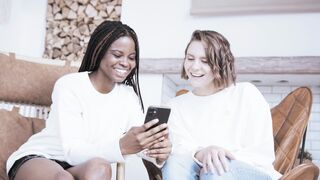 Funnyfuzzy - two women sitting on a couch looking at a cell phone | Trending HD Video