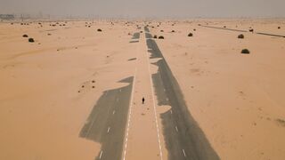 4K Computer Monitor - a desert road with a car driving on it | Trending HD Video