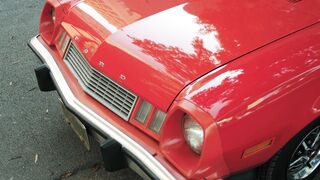 Electric car - close up of the front end and chrome wheel of a old red ford car | Trending HD V