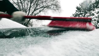 Winter Coat - person brushing of snow on vehicle | Trending HD Video