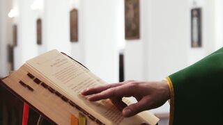 a priest reading the bible | Professional HD Video