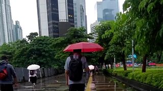 Vibrant Red Lanterns Decorating the Wet Streets of Jakarta