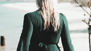 The Shy Snow Woman and the Cursed Ring - a woman in a long green dress walking on the beach | T