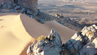 Travelon - aerial view of climbers on rocky desert summit | Trending HD Video