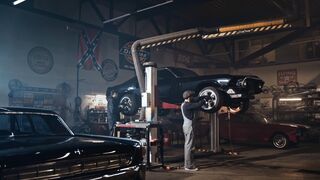 Electric car - a man is working on a car in a garage | Trending HD Video