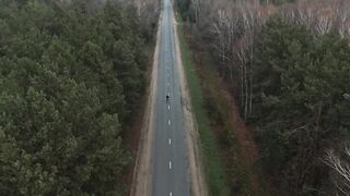 travelite - drone footage of a person riding a bicycle in road | Trending HD Video