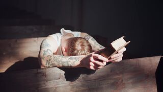 Notes on Being a Man - a man with tattoos reading a book | Trending HD Video