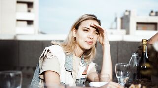 Woman Within - a woman sitting at a table with a bottle of wine | Trending HD Video