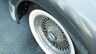 Carpet - close up footage of a classic white side wall tire on spoke rims | Trending HD Video