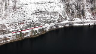 I Love Wallpaper - aerial shot of train on snowy cliffside | Trending HD Video