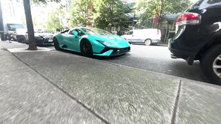 Electric car - a turquoise lamb car parked on the side of the road | Trending HD Video