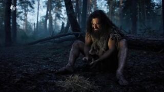 An ancient man trying to start fire with the help of Stones