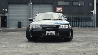Carrefour - sleek black nissan skyline in industrial setting | Trending HD Video