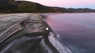 WallPics - 4K Wallpapers - aerial view of man walking on serene beach | Trending HD Video