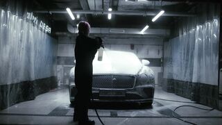 Electric car - a woman splashing soap on the black bentley | Trending HD Video