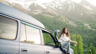 Car - a woman holding a cup of tea while sitting on a car hood | Trending HD Video