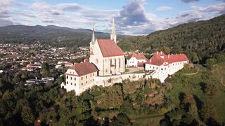 Wallpaper hanging - aerial view of historic austrian church | Trending HD Video