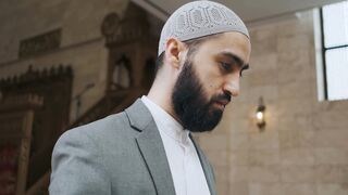 Notes on Being a Man - a man reading a quran while holding a prayer beads | Trending HD Video