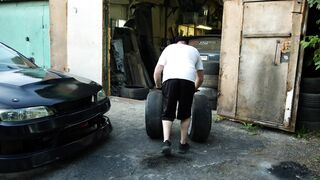 Notes on Being a Man - man rolling wheels of a car | Trending HD Video