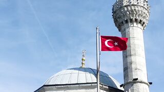 a mosque with a flag flying in the sky | Professional HD Video