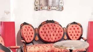 a room with orange furniture and a chandelier | Professional HD Video