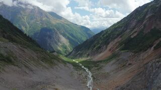 “Breathtaking Aerial View of a Lush Green Mountain Valley and Flowing River”