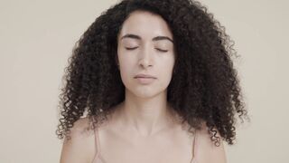 The Bold and the Beautiful - close up of a woman with various cosmetic products near her face |