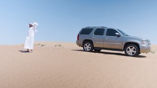 4K Computer Monitor - a man in white clothing standing in the desert next to a suv | Trending H