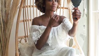 Woman Within - a woman holding a hand mirror while using a wet wipe on her face | Trending HD V