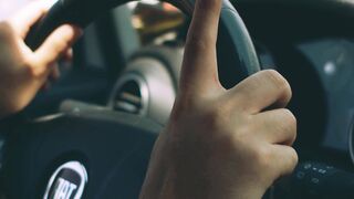 Carpet - a person driving a car with their hands on the steering wheel | Trending HD Video