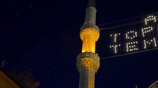 the blue mosque at night with a sign that says toplum | Professional HD Video
