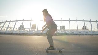 Woman Within - young woman skateboarding at urban sunset | Trending HD Video
