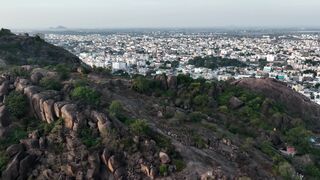 4K resolution - drone aerial view of rocky landscape and cityscape | Trending HD Video