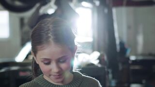 Carrefour - a young girl is working on a car in a garage | Trending HD Video