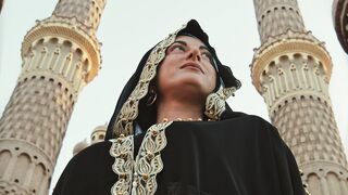 Woman - low angle photography of a woman between two towers | Trending HD Video
