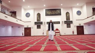 Notes on Being a Man - a man standing in a mosque with a white carpet | Trending HD Video
