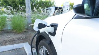 Carpet - a white electric car charging | Trending HD Video