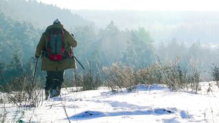 Winter Coat - a person walking on a land covered in snow | Trending HD Video