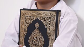 boy holding a quran | Professional HD Video