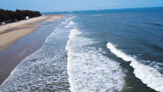 travelite - aerial view of waves crashing on an empty beach | Trending HD Video